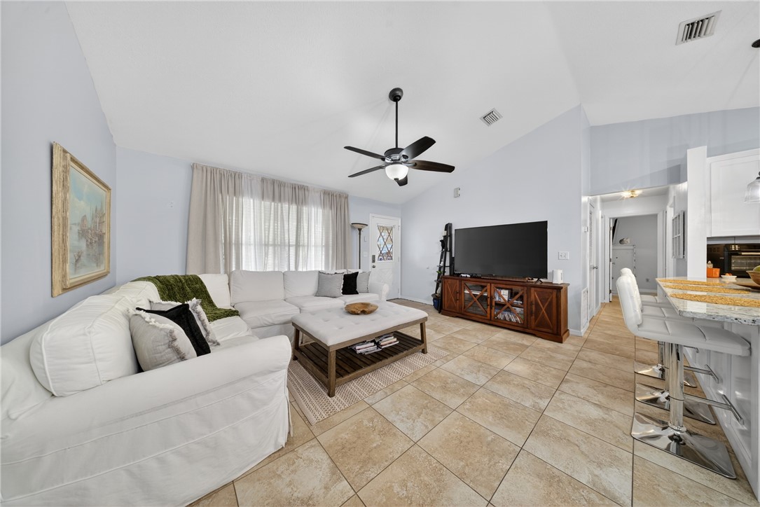 5809 Seagrape Drive Fort Pierce, FL 34982 - Photo 9 of 35 a living room with furniture and a flat screen tv