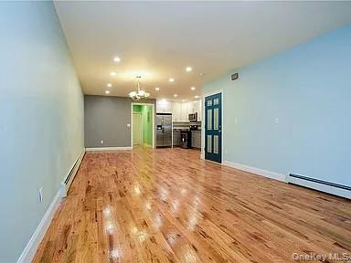 577 Logan Street Brooklyn, NY 11208 - Photo 2 of 8 a view of empty room with wooden floor