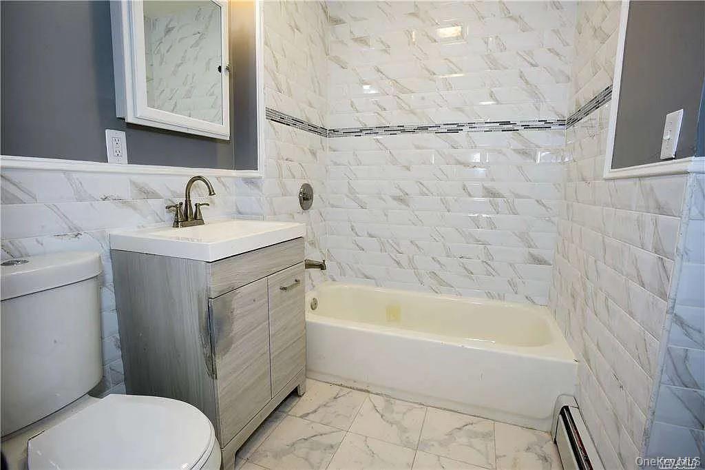 577 Logan Street Brooklyn, NY 11208 - Photo 8 of 8 a bathroom with a sink toilet and shower