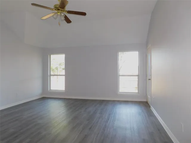 a spacious bathroom with a bathtub sink and mirror