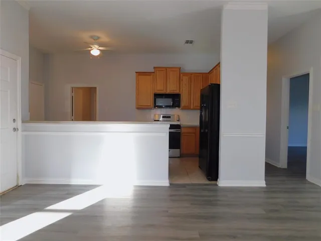 a kitchen with stainless steel appliances granite countertop a refrigerator sink and stove