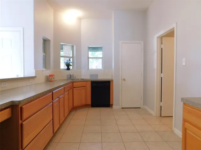 an empty room with wooden floor and fireplace
