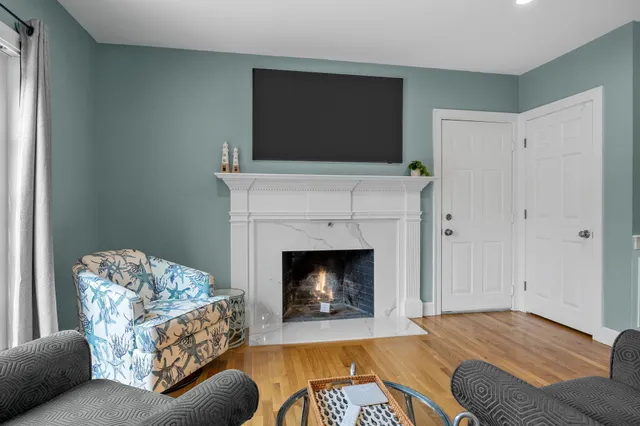 a view of an empty room with a fireplace and a window