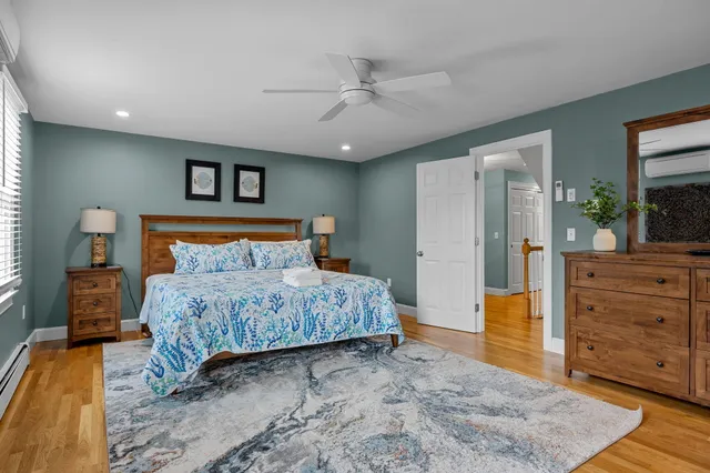 a bathroom with a toilet a sink a mirror and vanity