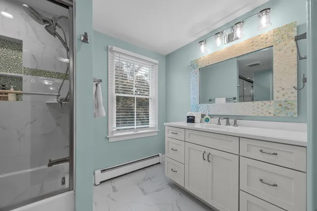 a living room with furniture a ceiling fan and a rug