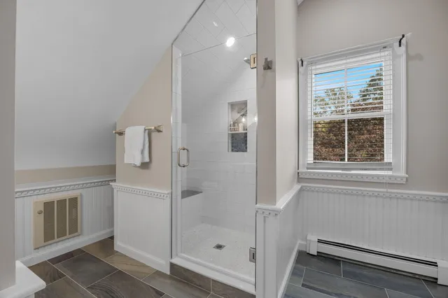 a view of a roof deck with table and chairs and wooden floor