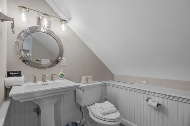 a view of a patio with table and chairs with wooden floor and fence