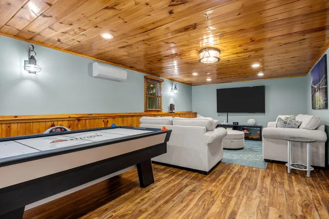 an aerial view of residential houses with outdoor space and trees