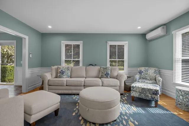 a living room with furniture and a chandelier