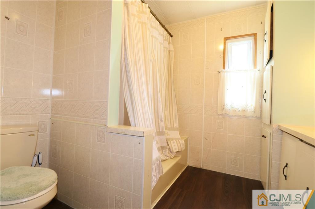 7 Byron Road North Brunswick, NJ 08902 - Photo 14 of 25 a bathroom with a sink and a mirror