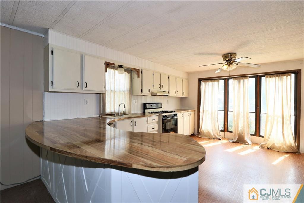 7 Byron Road North Brunswick, NJ 08902 - Photo 17 of 25 a kitchen with stainless steel appliances granite countertop a sink window and cabinets
