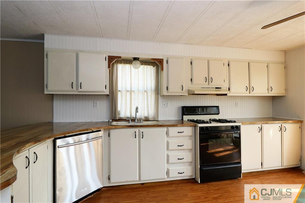 7 Byron Road North Brunswick, NJ 08902 - Photo 20 of 25 a kitchen with granite countertop white cabinets and stainless steel appliances