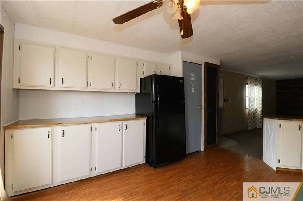 7 Byron Road North Brunswick, NJ 08902 - Photo 21 of 25 a kitchen with a refrigerator and cabinets