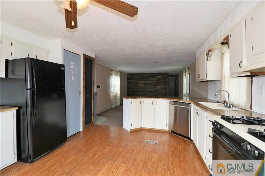 7 Byron Road North Brunswick, NJ 08902 - Photo 22 of 25 a kitchen with stainless steel appliances a refrigerator and a stove top oven
