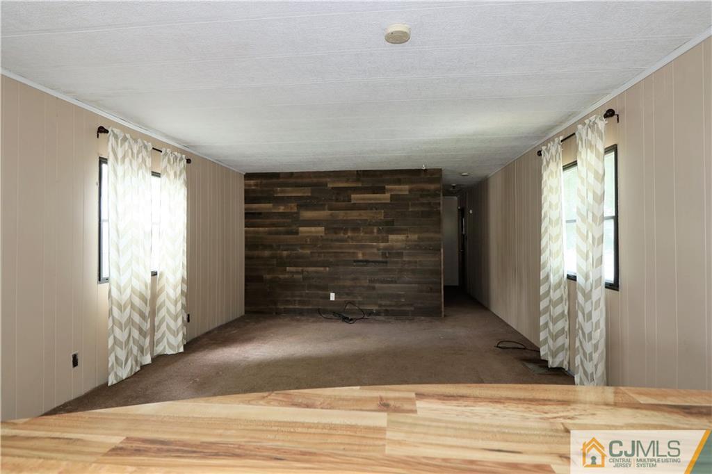 7 Byron Road North Brunswick, NJ 08902 - Photo 8 of 25 a view of an empty room with wooden floor and windows