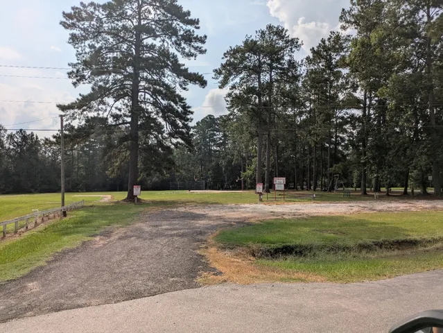 a bedroom with a bed and a view of kitchen
