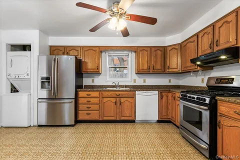 a kitchen with stainless steel appliances granite countertop a stove a refrigerator and a sink