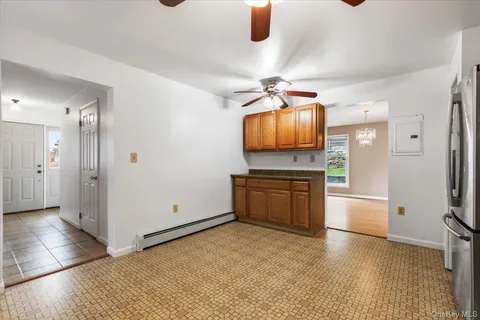 a kitchen with stainless steel appliances kitchen island granite countertop a stove and a refrigerator