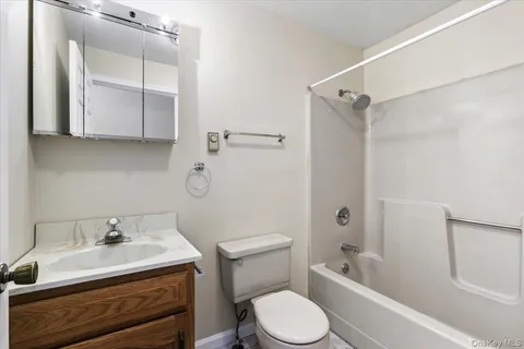 a bathroom with a sink toilet vanity and tub
