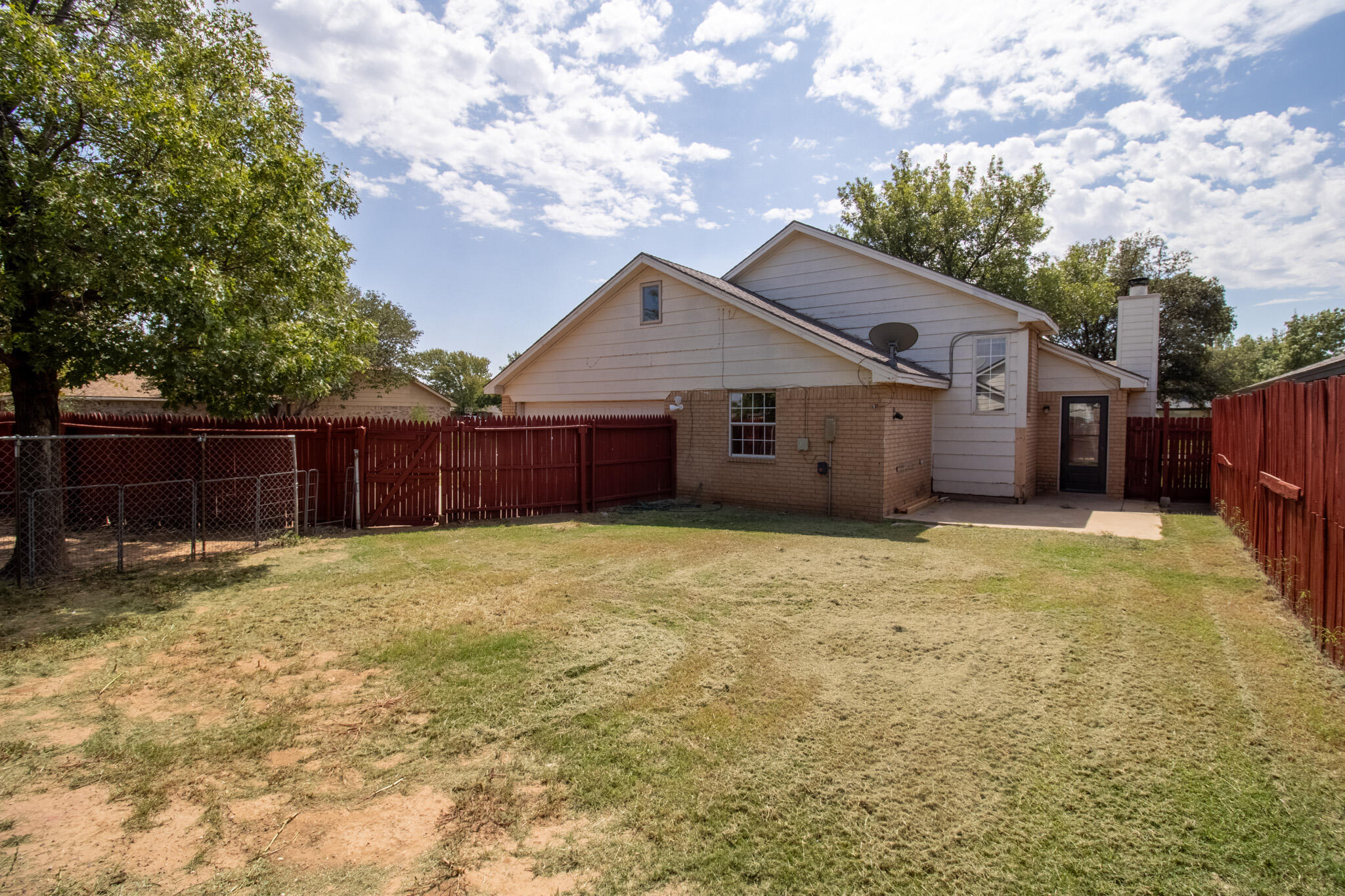 2202 93rd Place Lubbock, TX 79423 - Photo 11 of 11 a house with a large tree in front of it