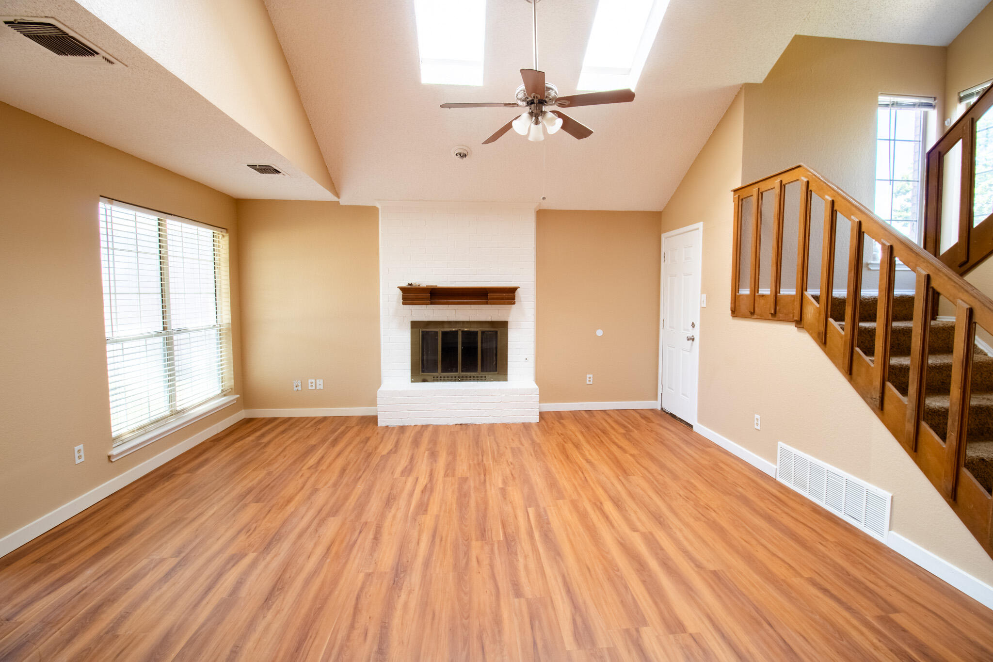 2202 93rd Place Lubbock, TX 79423 - Photo 3 of 11 a view of an empty room with wooden floor fireplace and a window