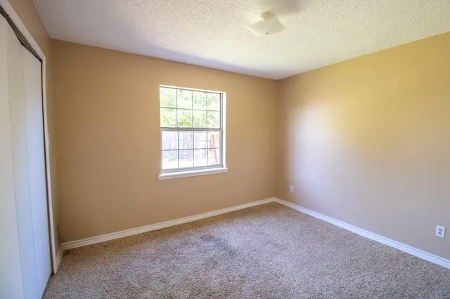 an empty room with a empty space and a window
