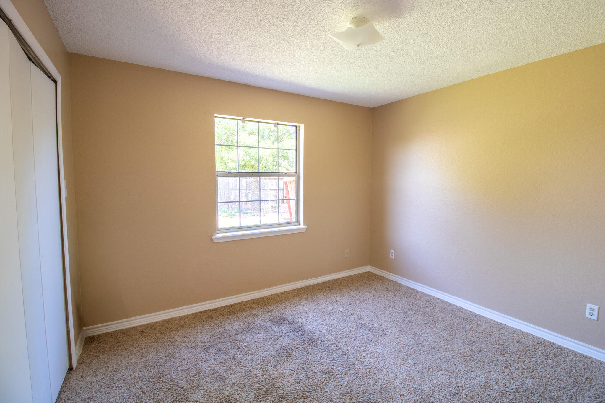 2202 93rd Place Lubbock, TX 79423 - Photo 6 of 11 an empty room with a empty space and a window