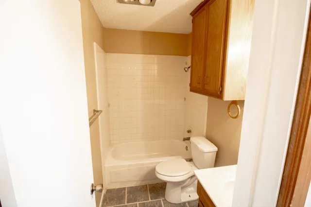 a bathroom with a toilet and a shower
