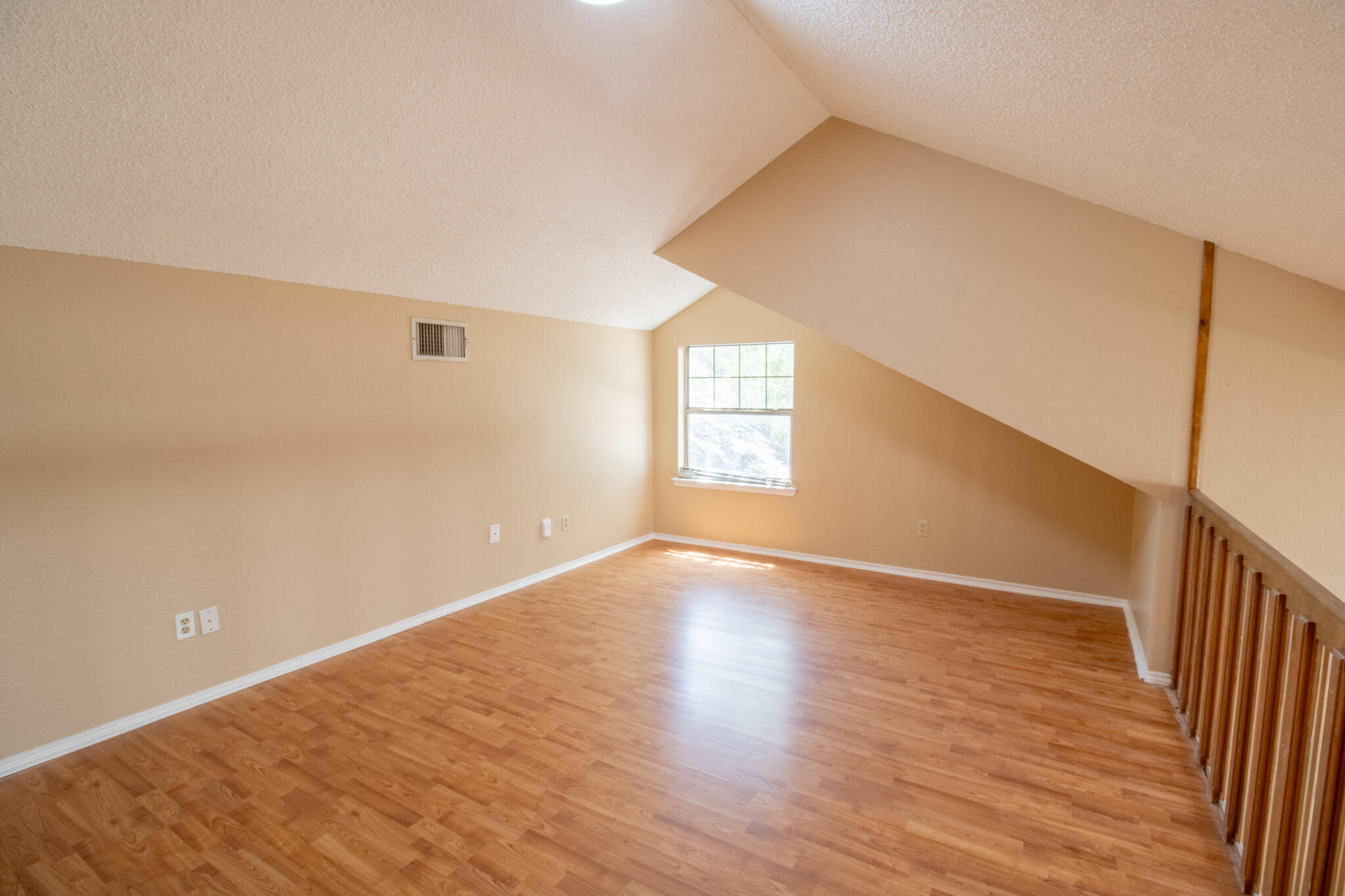 2202 93rd Place Lubbock, TX 79423 - Photo 8 of 11 a view of an empty room with wooden floor and window