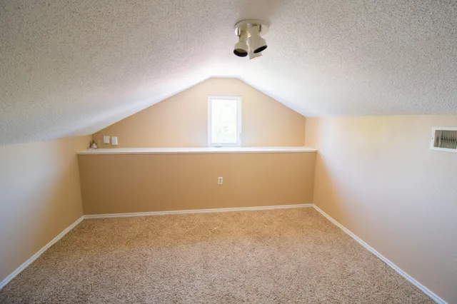 an empty room with a empty space and windows