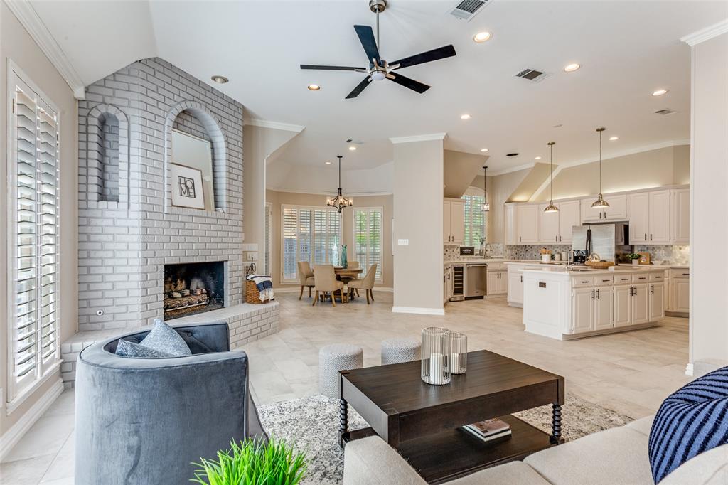 7702 Tillman Hill Road Colleyville, TX 76034 - Photo 11 of 26 a living room with furniture a fireplace and a chandelier