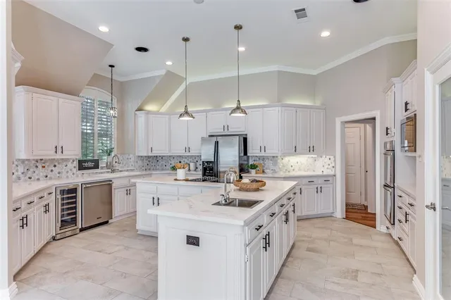a kitchen with white cabinets and white appliances