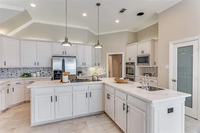 a kitchen with a sink stove and cabinets