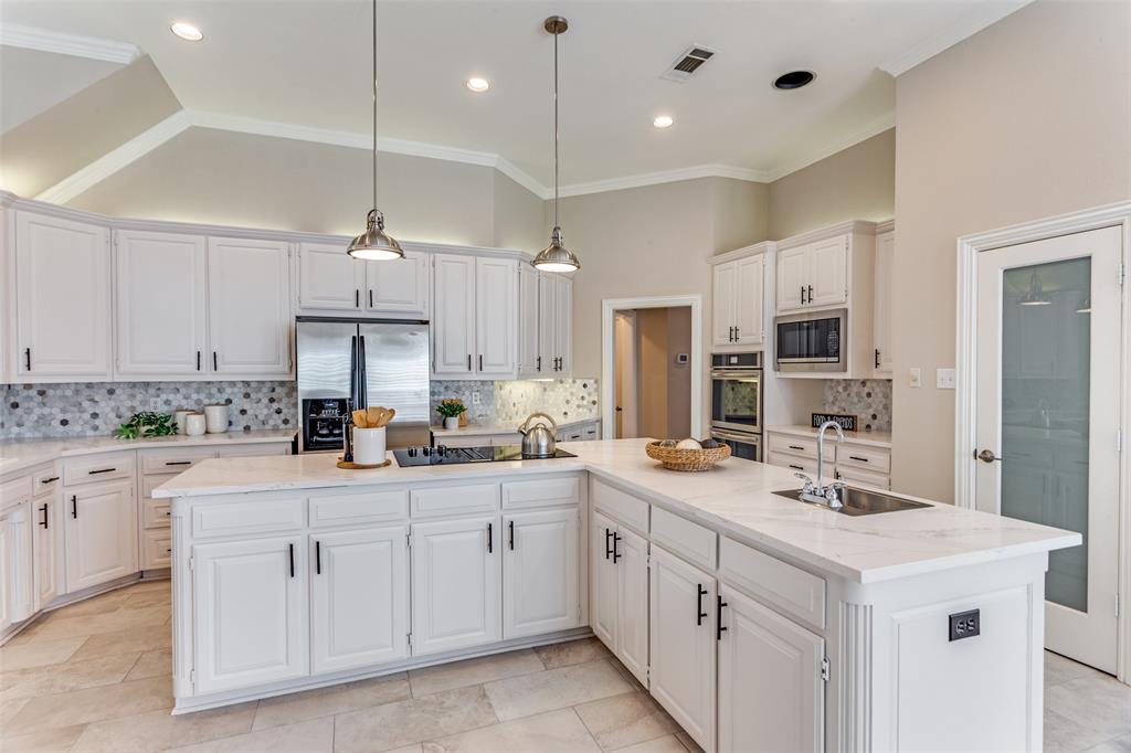7702 Tillman Hill Road Colleyville, TX 76034 - Photo 14 of 26 a kitchen with white cabinets and white appliances