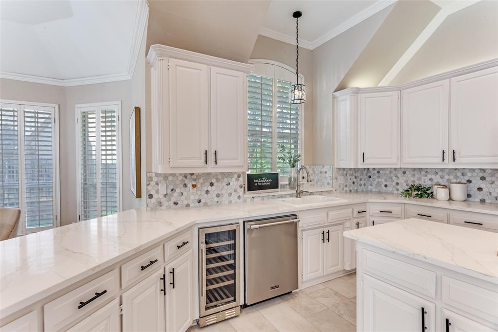 7702 Tillman Hill Road Colleyville, TX 76034 - Photo 15 of 26 a kitchen with a sink stove and cabinets