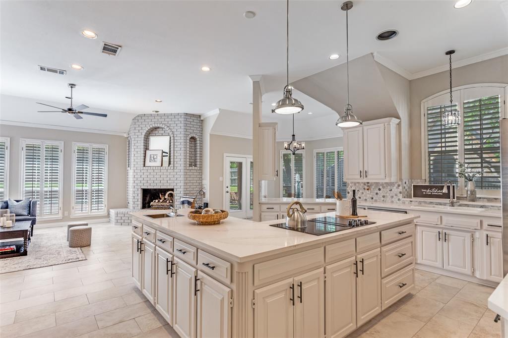 7702 Tillman Hill Road Colleyville, TX 76034 - Photo 26 of 26 a kitchen with sink stove and white cabinets with wooden floor