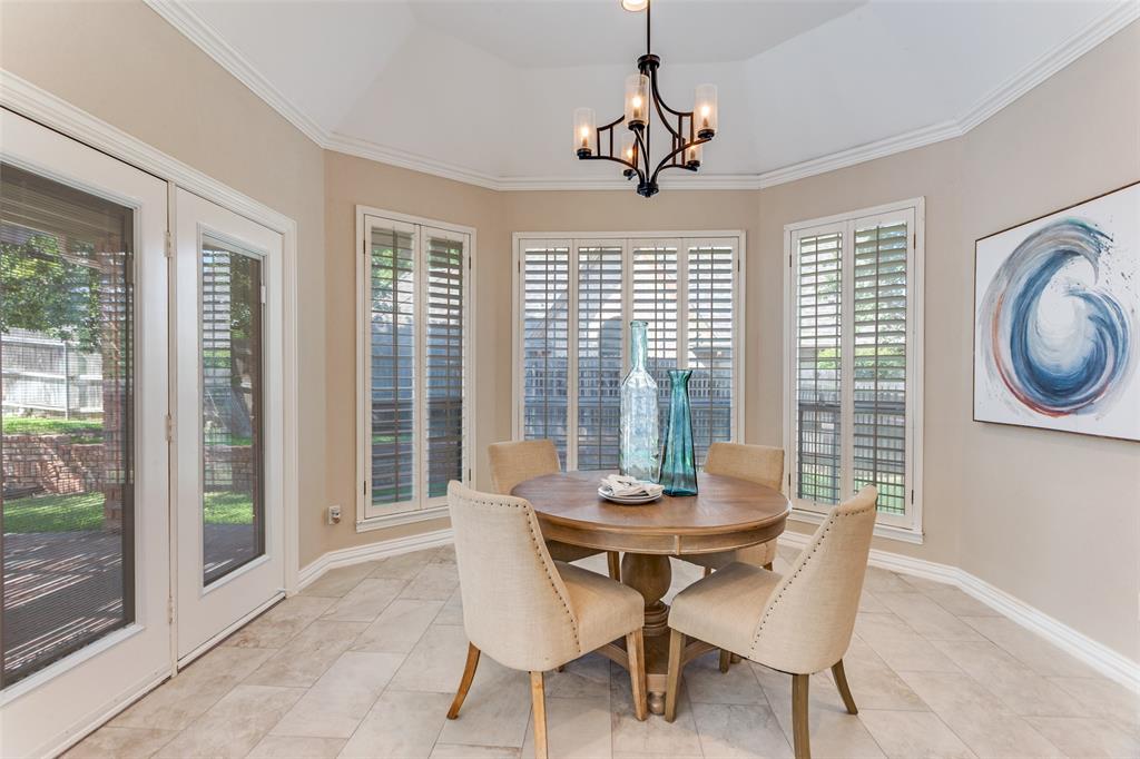 7702 Tillman Hill Road Colleyville, TX 76034 - Photo 16 of 26 a view of a dining room with furniture large windows and wooden floor