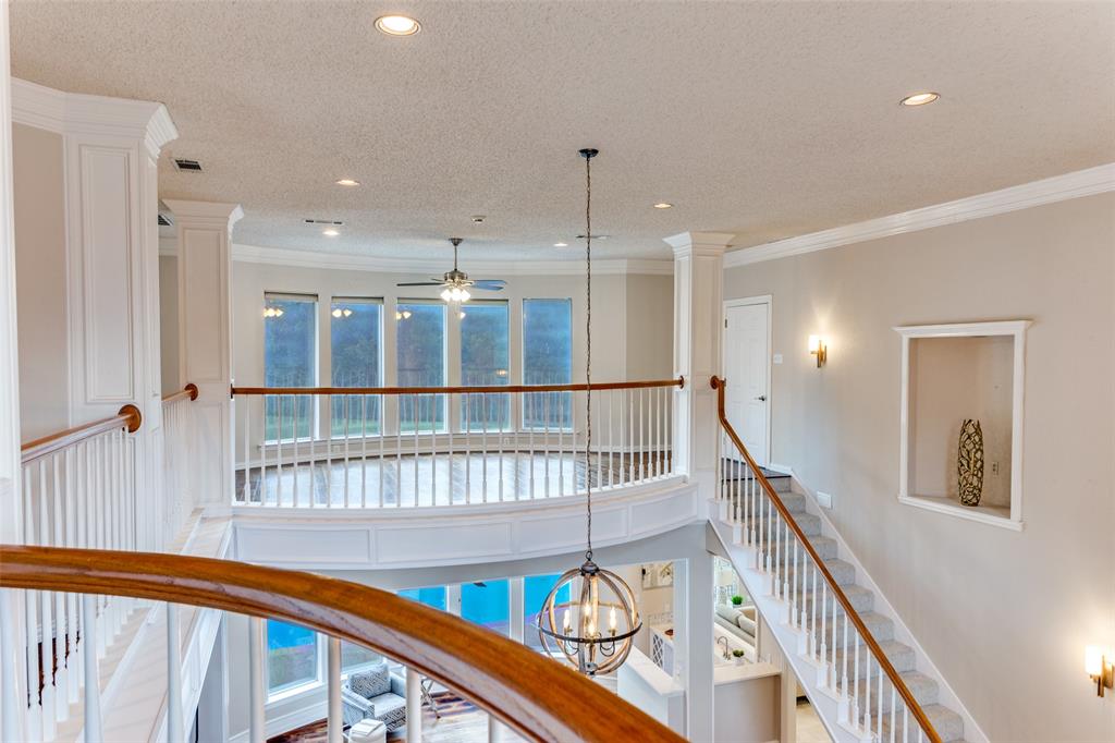 7702 Tillman Hill Road Colleyville, TX 76034 - Photo 18 of 26 a view of a hallway with wooden floor and staircase