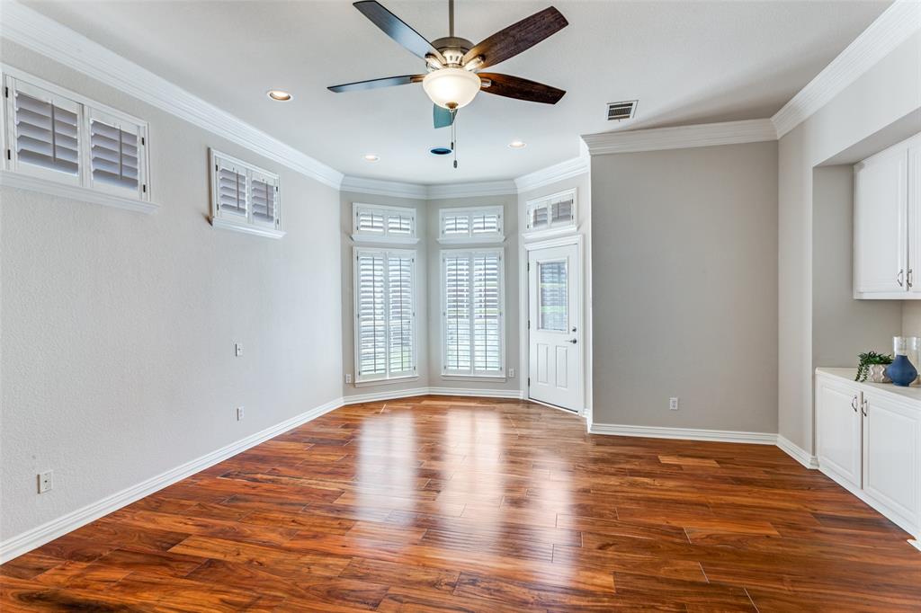 7702 Tillman Hill Road Colleyville, TX 76034 - Photo 22 of 26 a view of an empty room with window and wooden floor