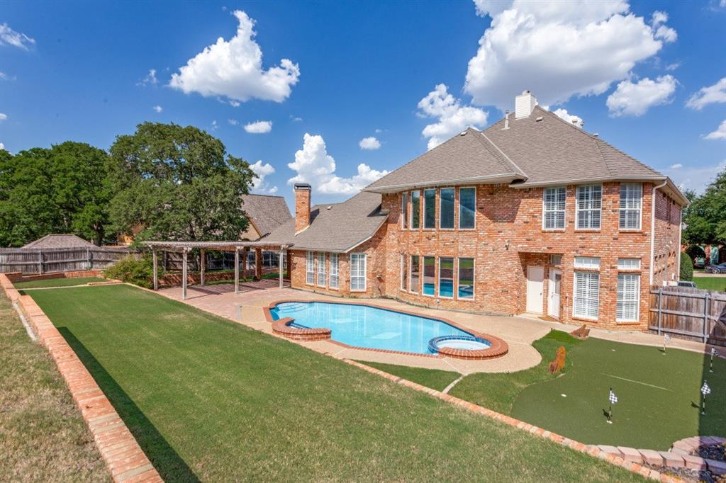 7702 Tillman Hill Road Colleyville, TX 76034 - Photo 3 of 26 a front view of a house with a yard