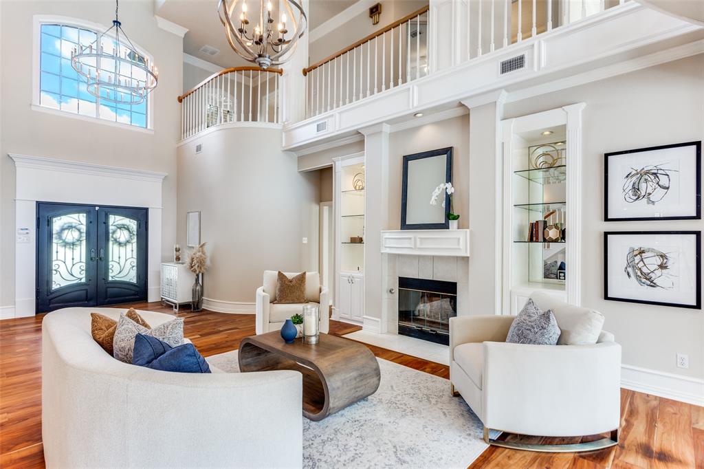 7702 Tillman Hill Road Colleyville, TX 76034 - Photo 7 of 26 a living room with furniture a fireplace and a chandelier