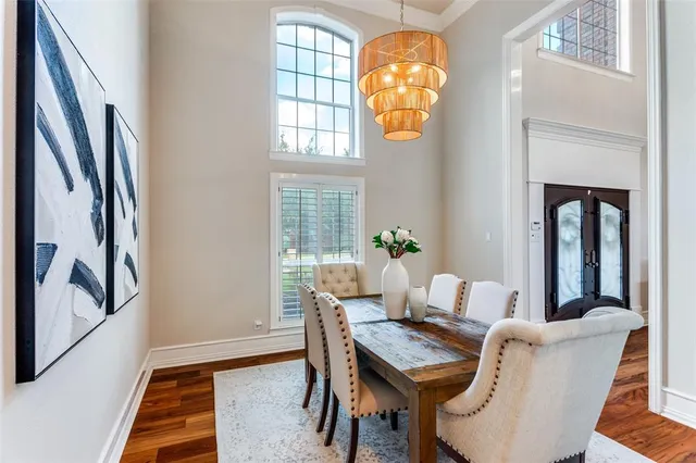 a living room with furniture a fireplace and a chandelier