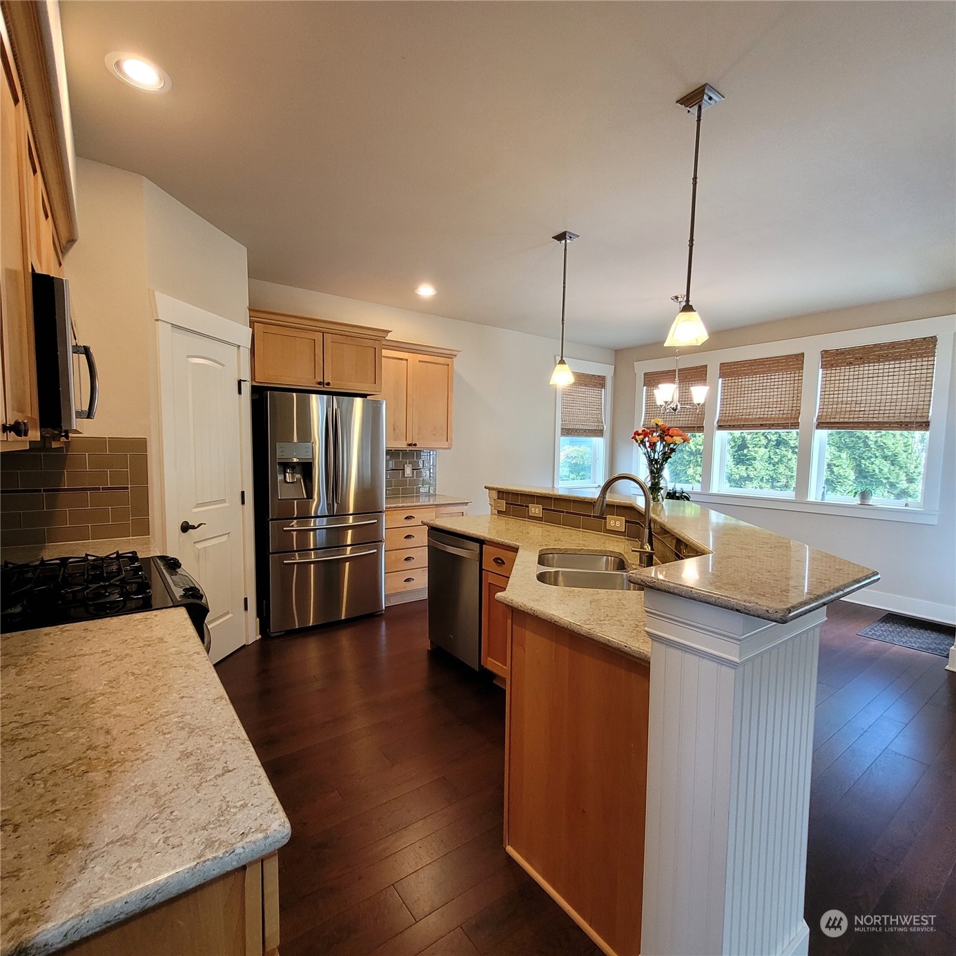 151 Craftsman Court Sequim, WA 98382 - Photo 13 of 40 a kitchen with stainless steel appliances granite countertop a sink a stove and a wooden floors