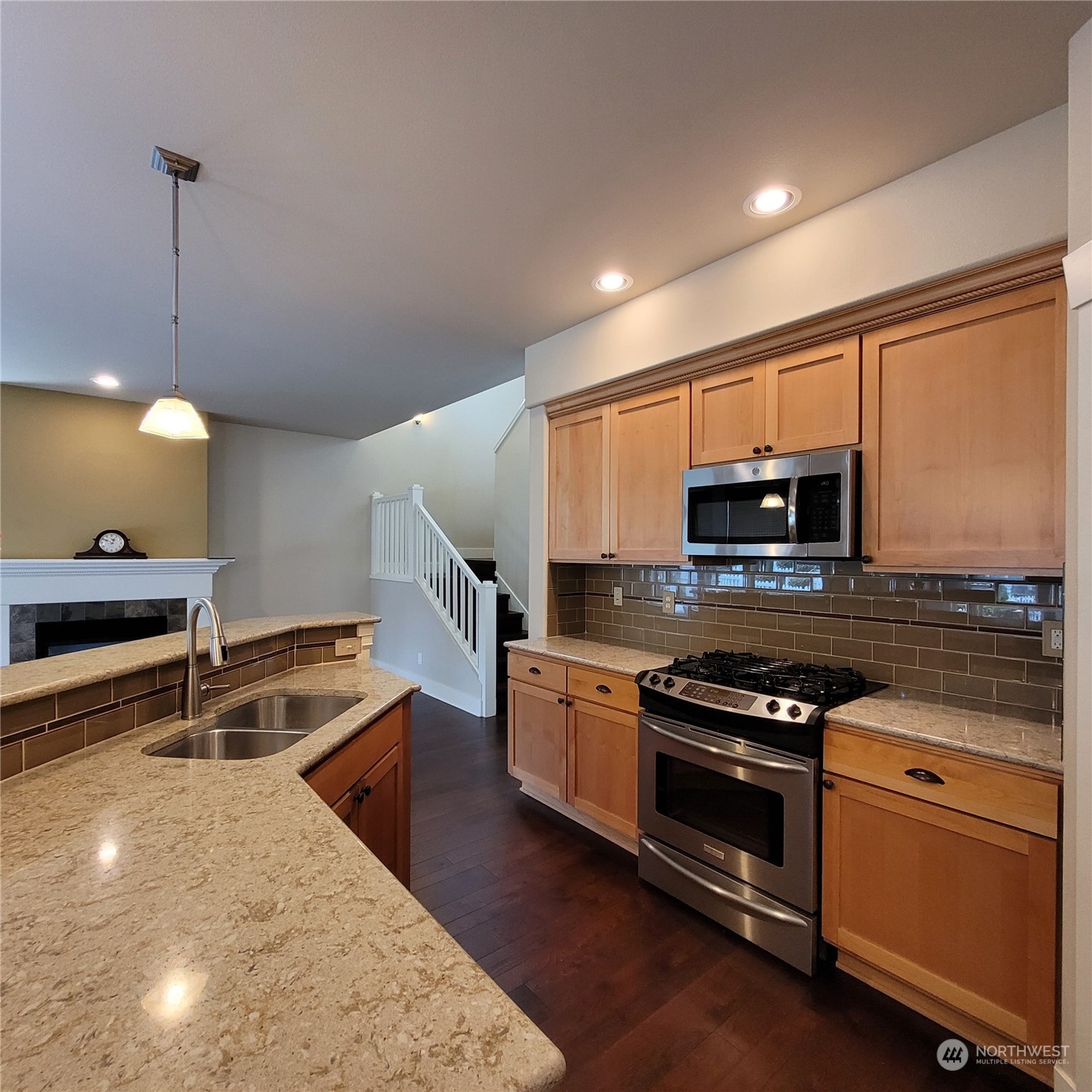 151 Craftsman Court Sequim, WA 98382 - Photo 14 of 40 a kitchen with stainless steel appliances a stove a microwave and white cabinets