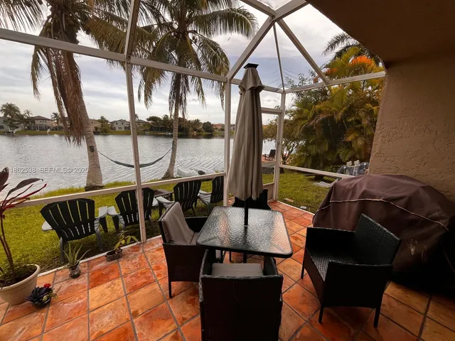 a view of a balcony with chairs and wooden floor