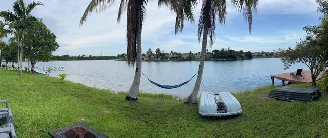a view of a lake with a palm and palm trees