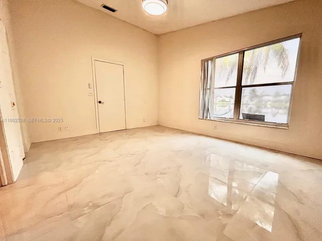 an empty room with a empty space and windows