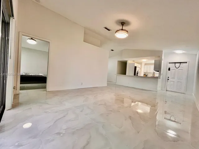 a living room with furniture and large windows