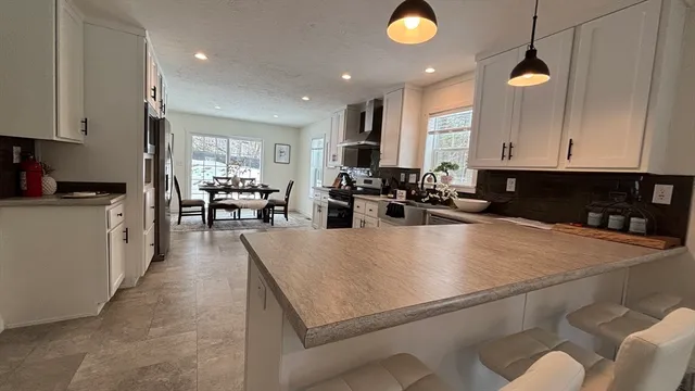 a view of a dining room with furniture window and outside view