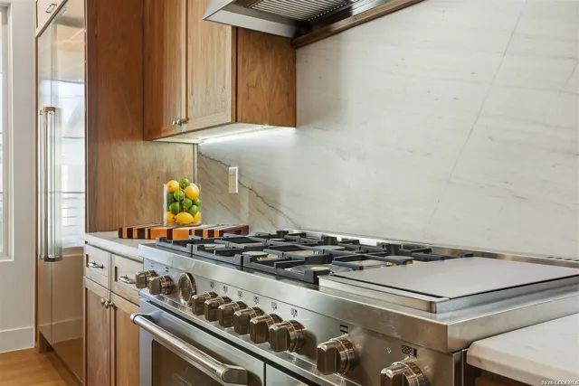 a kitchen with white cabinets and sink